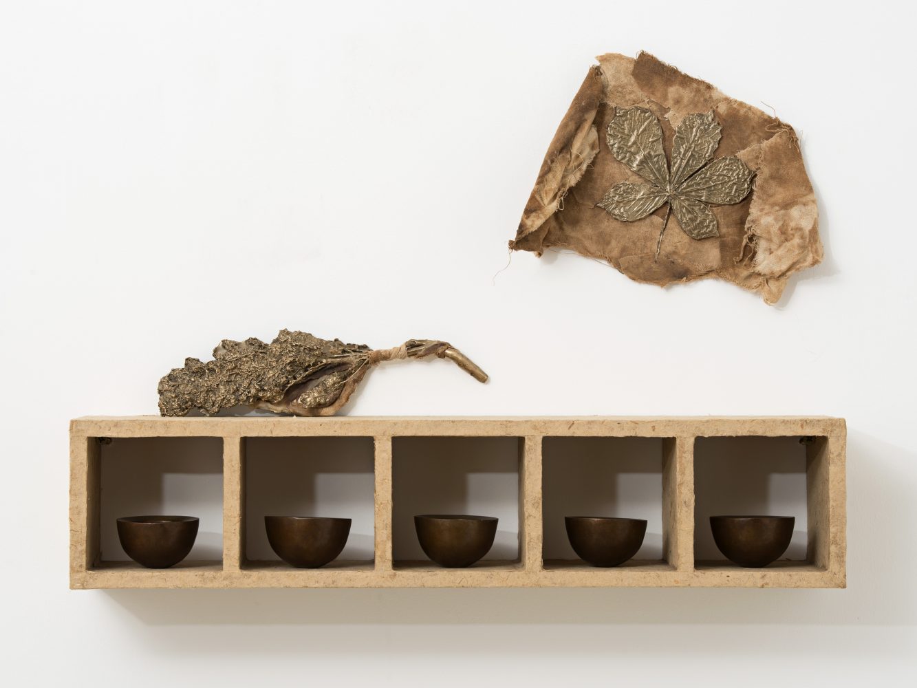 Esca, 1997  polished patinated bronze, horse-chestnut seeds, bali-paper, cloth, wood  33 x 61.6 x 13.7 cm, 13 x 24 1/4 x 5 3/8 ins  © Michelle Stuart